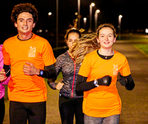 A male and female volunteer running