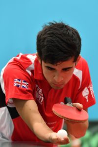 Athlete Kim Daybell ready to serve holding table tennis bat and ball