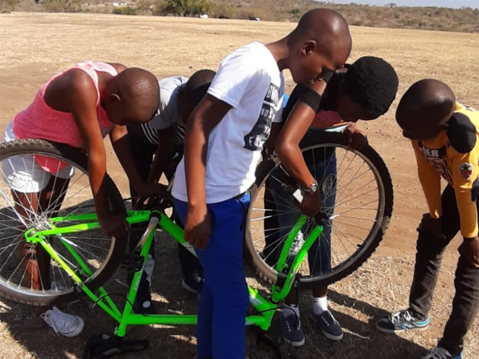 Kids in South Africa repairing a bicycle