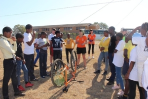Students teaching bike maintenance to school children