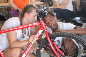 close up of students fixing a bike