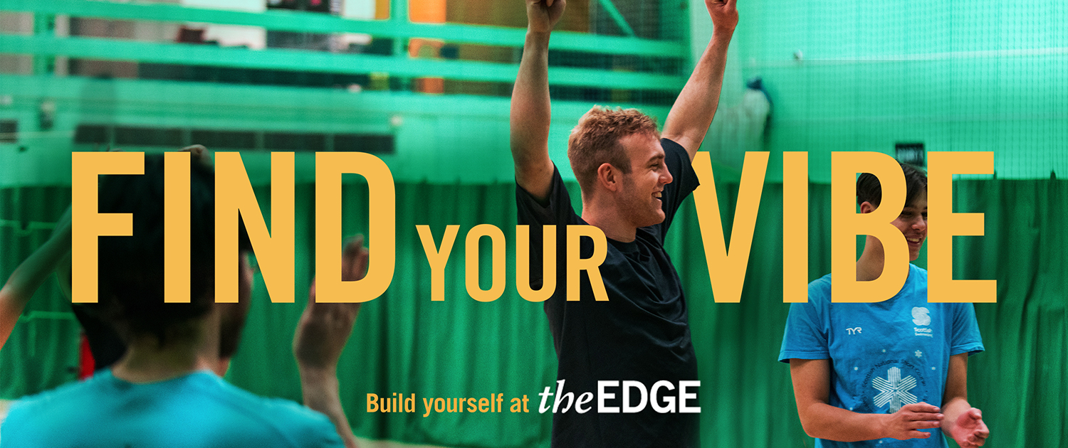 Man doing celebratory pose in sports hall with people around him clapping. Text says: 'Find your vibe. Build yourself at The Edge'