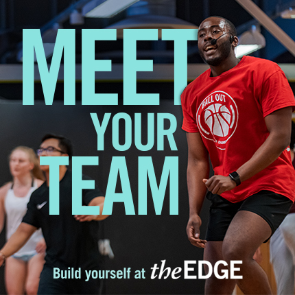 Group in an exercise class. Instructor with microphone at the forefront. Text says: 'Meet your team. Build yourself at The Edge'