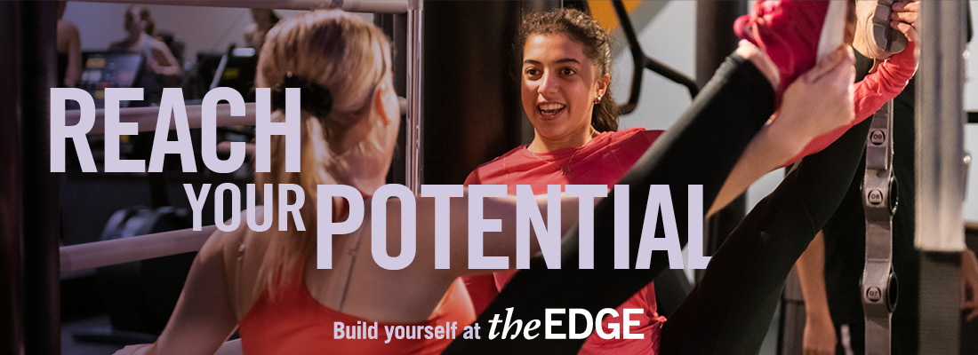 Two girls engaged in exercise class. Text says 'Reach your potential. Build yourself at The Edge.'