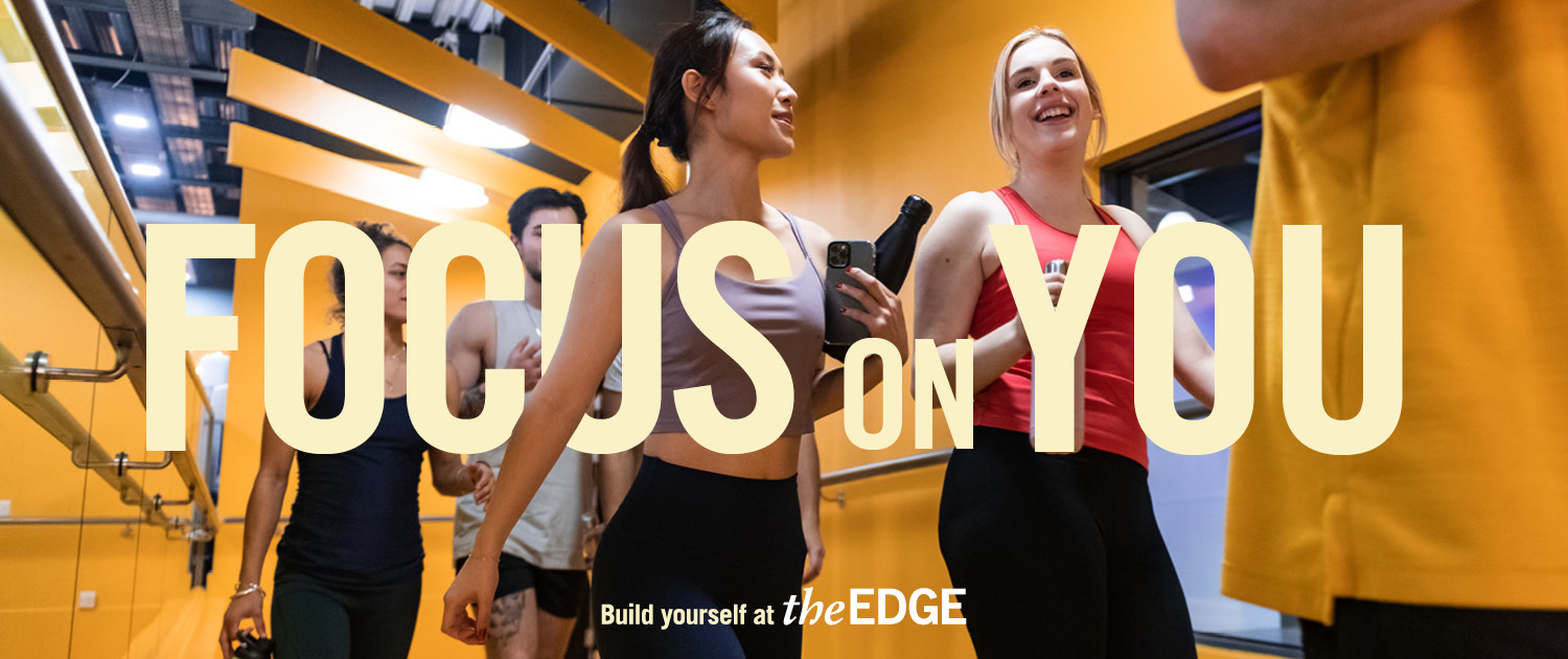 People walking into an exercise class. Text says 'Focus on you. Build yourself at The Edge.'