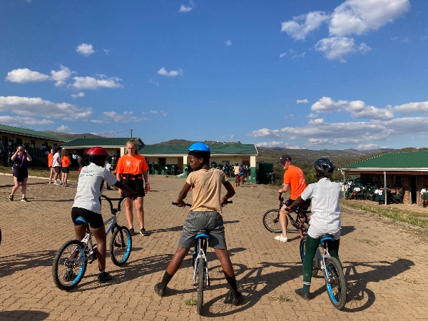 Volunteers helping kids ride bikes