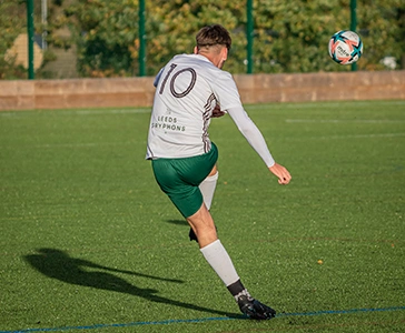 Boy kicking football