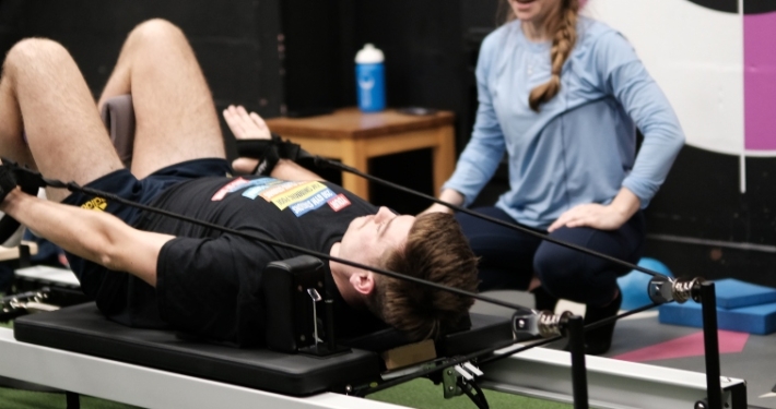 Member doing reformer pilates