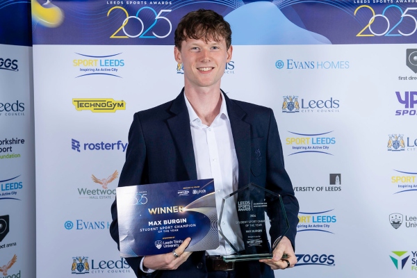Young man posing with award