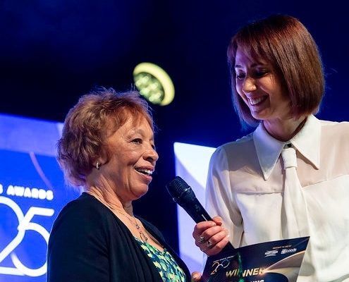 Woman receiving award on stage