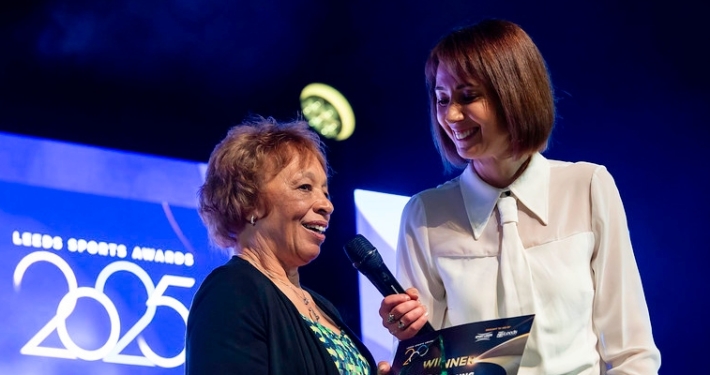 Woman receiving award on stage