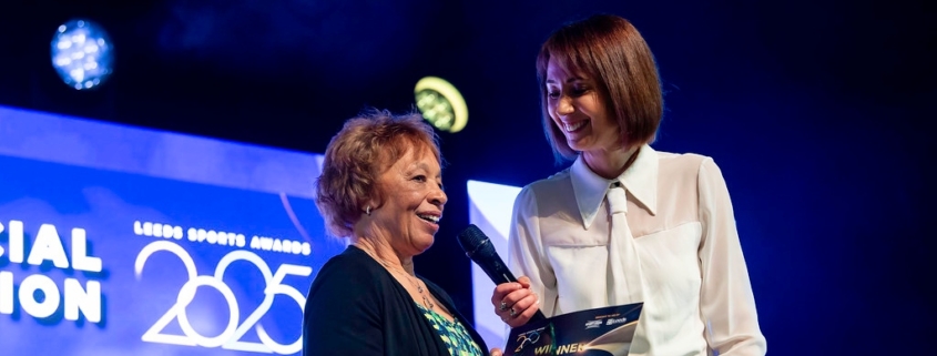 Woman receiving award on stage