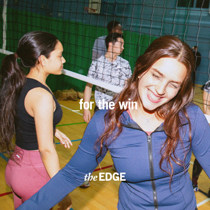 Student smiling playing volleyball