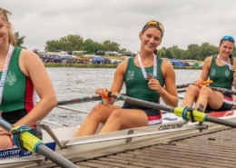 Female rowers Four female rowers sitting in boat with medals