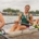 Four female rowers sitting in boat with medals