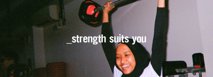 Strength suits you 1100 x 400 Young woman lifting barbell above her head