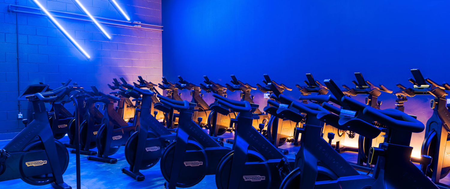Dark spin studio with row of bikes